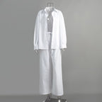 White long-sleeve button-down shirt and matching drawstring trousers on a clear mannequin.