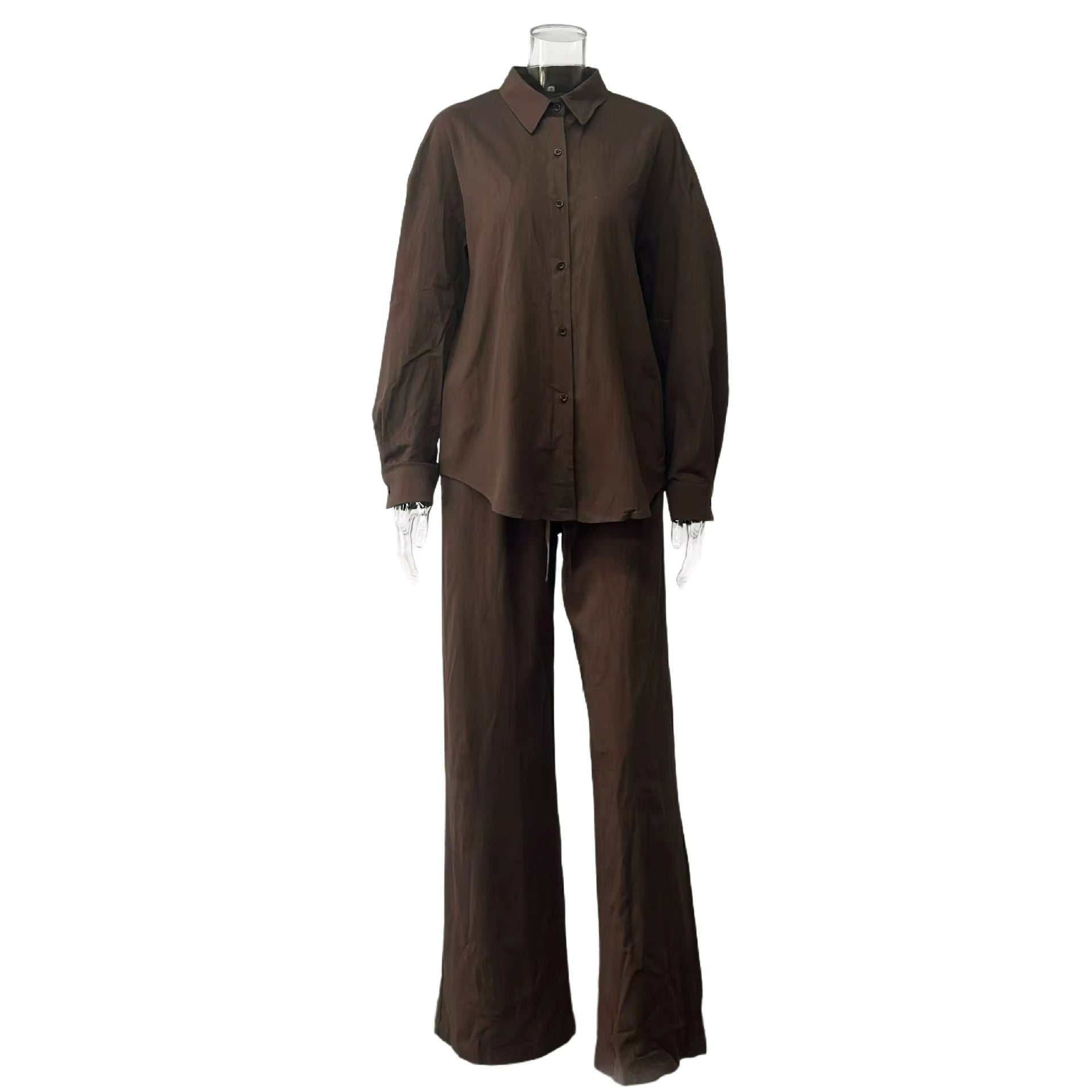 Brown two-piece fabric suit with a long-sleeve button-down shirt and matching wide-leg trousers on a clear mannequin.