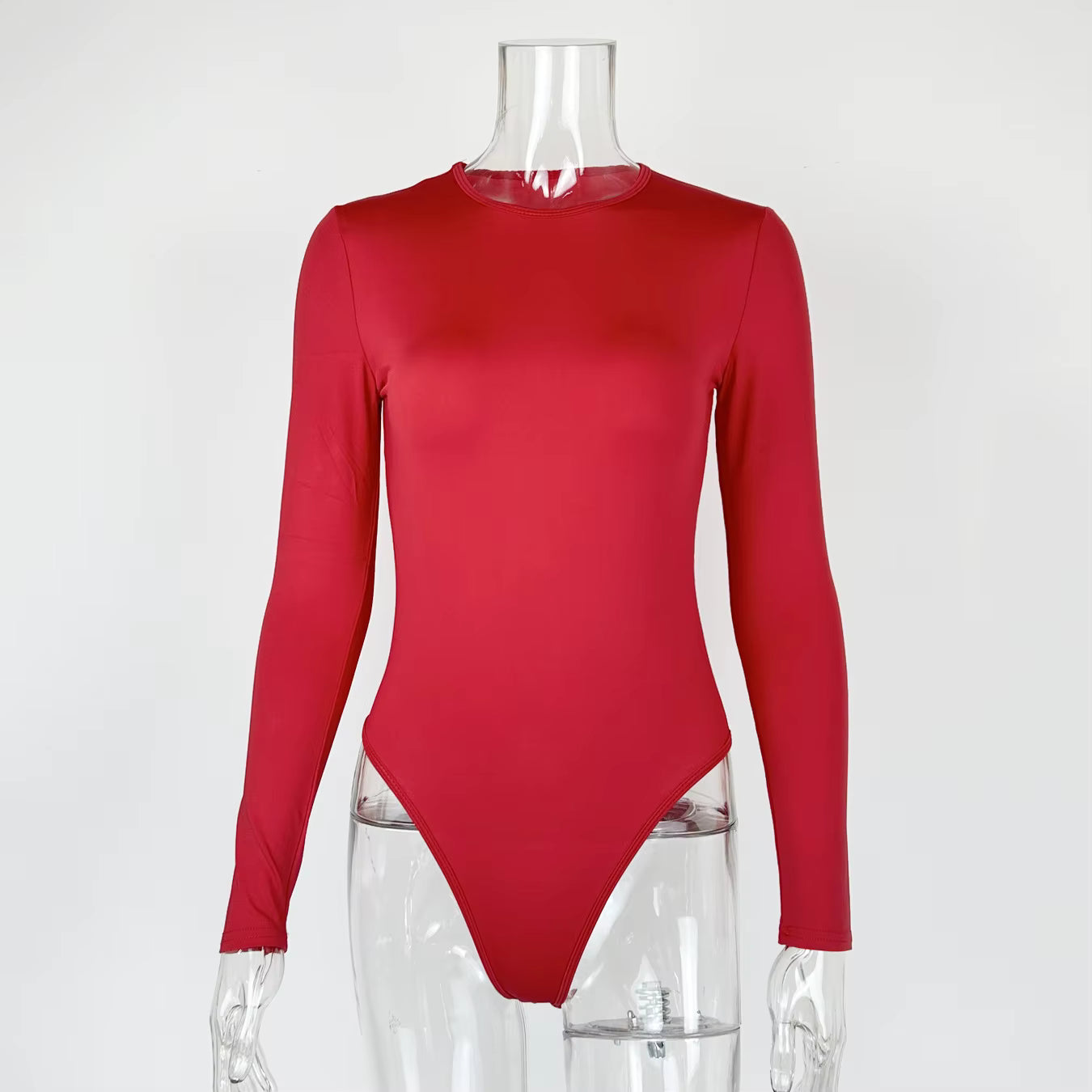 Red long sleeve fabric bodysuit with a crew neck on a clear plastic mannequin.
