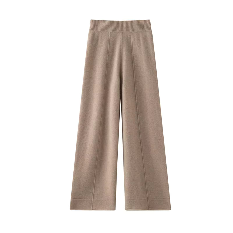 Tan wool knit wide leg pants with a high ribbed waistband and vertical seams down the center of each leg.