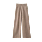 Tan wool knit wide leg pants with a high ribbed waistband and vertical seams down the center of each leg.
